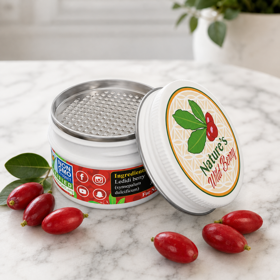 Nature's Wild Berry Travel Tin with fresh miracle berries on a marble counter